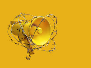 megaphone wrapped in barbed wire. the concept of banning freedom of speech. censorship barbed wire megaphone