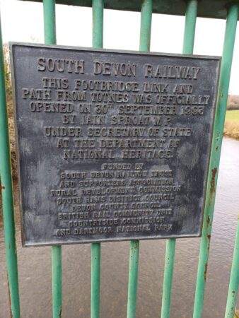 sign on the way up to the walking bridge across the river dart
