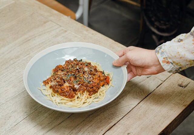 Photo by Ketut Subiyanto: https://www.pexels.com/photo/crop-woman-putting-plate-of-spaghetti-bolognese-on-table-4350116/