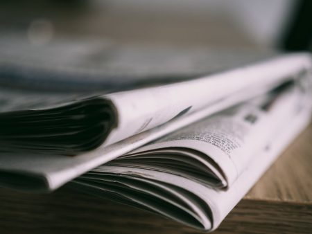 Photo by Lisa Fotios: https://www.pexels.com/photo/close-up-of-newspapers-on-wooden-table-18287623/