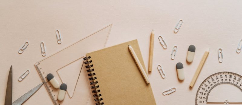 Photo by olia danilevich: https://www.pexels.com/photo/spiral-notebook-pencils-and-paper-clips-flatlay-5088017/