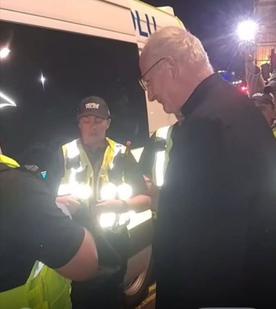 Father Jim Barlow under arrest