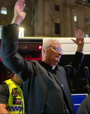 Father Jim Barlow under arrest