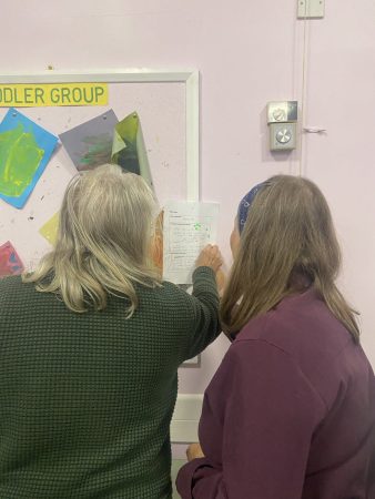 Two Assembly Members voting on the questions to be taken forward