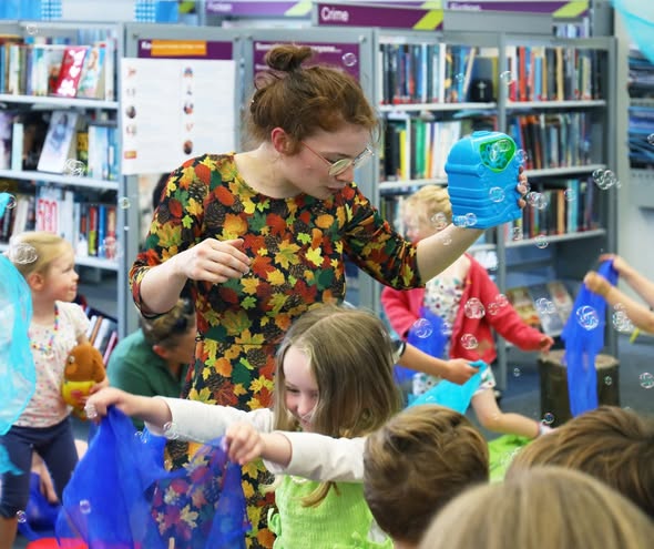 libraries: Children playing with bubbles in a library