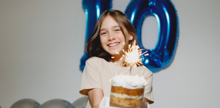 Photo by Jonathan Borba: https://www.pexels.com/photo/a-girl-sitting-on-the-ground-holding-a-birthday-cake-18680458/