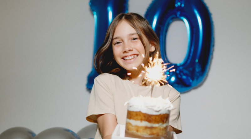 Photo by Jonathan Borba: https://www.pexels.com/photo/a-girl-sitting-on-the-ground-holding-a-birthday-cake-18680458/